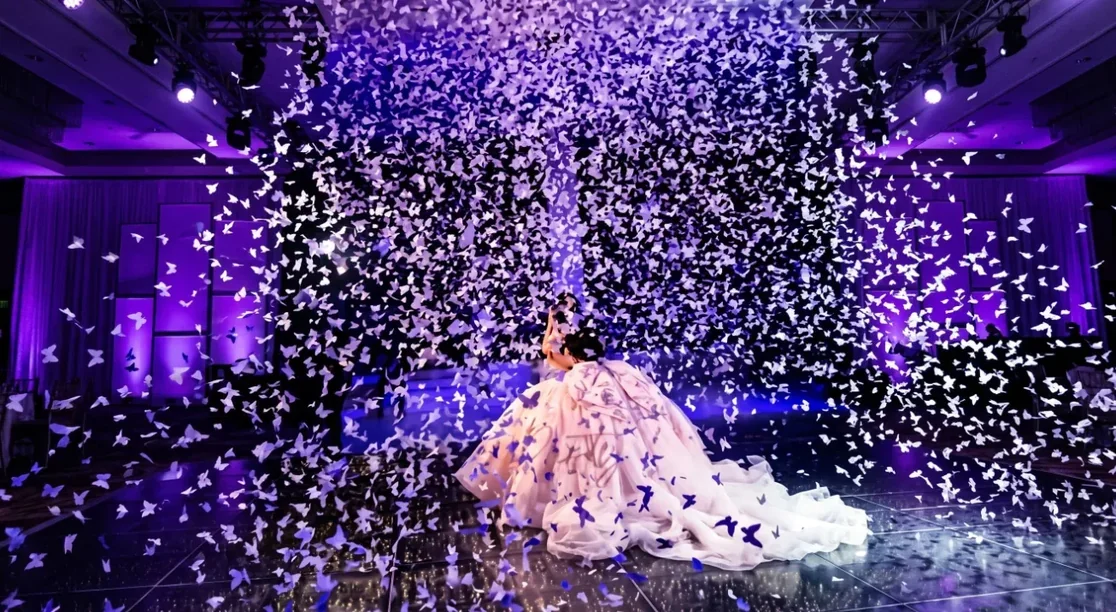 Lluvia de mariposas cayendo sobre una quinceañera durante su vals