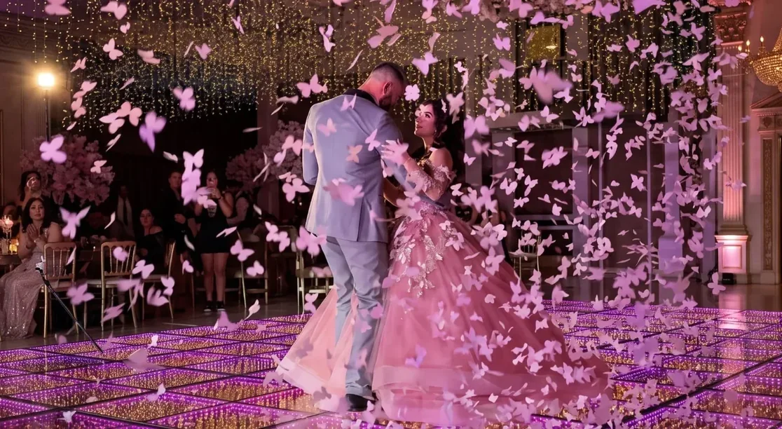 Lluvia de mariposas rosa durante el vals de una quinceañera